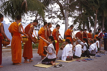 Buddhist monks begging early morning in luang prabang