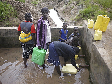 UGANDA Collecting water from hand-pumped well, Gulu. PHOTO by Sean Sprague