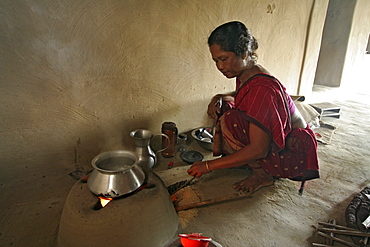 Bangladesh alpona ritchil of the garo tribal minority, making tea on a wood fire, haluaghat, mymensingh region