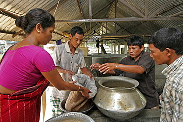 Bangladesh family buying fish fingedrlings for stocking the pond on the farm, at a hatchery in haluaghat, mymensingh region. They are members of the garo tribal minority