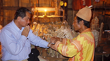 THAILAND Visit to Ban Pan Tong, a Lahu village which practices traditional religion. The local 'tobo' or shaman at the village chapel shrine conducting Animist ceremony. Photo by Sean Sprague