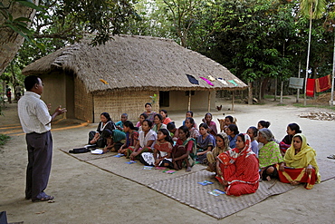 Bangladesh a group of women of the garo tribal minority attend a session of instruction about fish farming from a specialist at haluaghat, mymensingh region