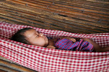 Cambodia baby asleep in hammock. Kampot province.