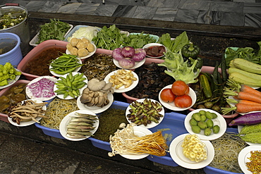 China display of fresh vegetables outsdie a restaurant dali town, yunnan province.