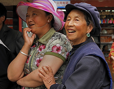 China naxi minority, enjoying a street performer, lijian, yunnan province.