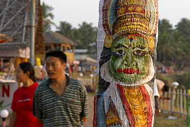 India kathakali dancer painted on a cocnut tree. Varkala beach resort, kerala.