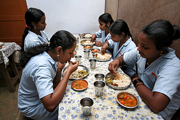 India queens garments, a project for poor women run by the congregation of the mother of carmel (cmc) sisters, kottayam, kerala. The young women serving and eating lunch, which they prepare themselves.