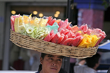 Guatemala street seller carrying food on head. pedro sacatepequez