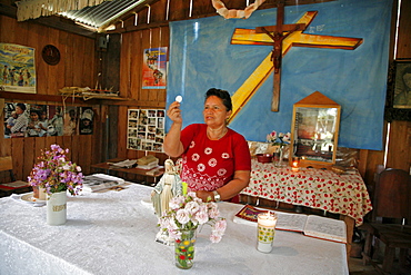 Guatemala santa rita village of returnees, in peten. community fled guatemala during violence of 1980s in times of peace have returned to settle in jungle lowlands. Liturgy of word celebrated at a small catholic chapel in village. Eucharist minister elvira de jesus corado