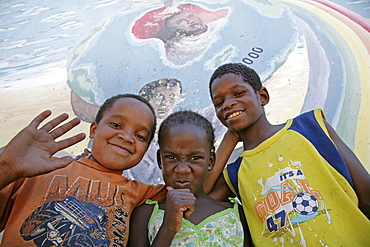 Namibia child at bernard nordkamp (youth) center, katatura, a black township of windhoek, dating from apartheid. country very high rates, mural behind depicts struggle against aids