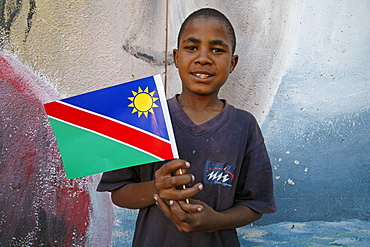 Namibia child holding national flag at bernard nordkamp (youth) center, katatura, a black township of windhoek, dating from apartheid