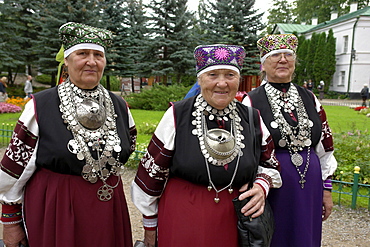 Russia women wearing traditional estonian dress at pechersky caves monastery, pskov district, founded on august 28th 1473 by saint jonah sheshnik