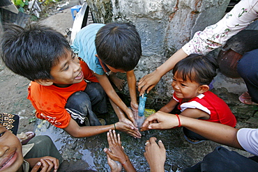 Children washing hands prior to eating, phnom pen