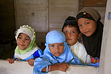 Indonesia muslim girls at a koranic -school in banda aceh. Photograph taken in banda aceh, -december 2006, 2 years after tsunami of december 26th 2004 devasted much of coastal region. Taken to illustrate reconstruction work projects of (catholic relief services) of sponsored photo tour 