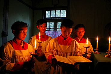 Myanmar boys reciting gospel in candle light at catholic -seminary at myitkyina, a largely kachin community in north burma near chinese border 