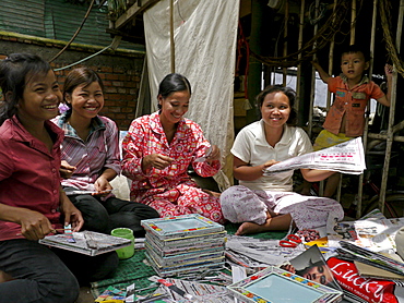 CAMBODIA Women trained by CSARO to make handicrafts from recycled materials. Some are former waste pickers whose lives have been improved by the project. Kim Savoeun, 49, is the mother of 2 of the girls working here. The settlement slum of San Sok, 10 kilometres outsdie Phnom Penh