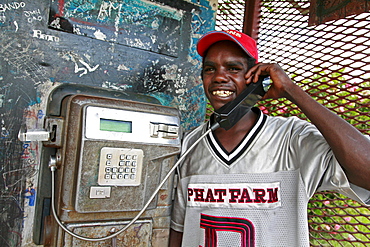 Australia. Young man making phone call, aborigine community of , or beswick, arnemland, northern territory. 2007