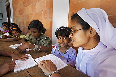 India. Study and reading time, helped by sister bincy joseph.Mary Matha bala bhavan, a girls orphanage run by syro-malabar catholic missionary sisters of mary immaculate (msmi), chamal village, thamarassery diocese, khozikode, kerala. 2007   