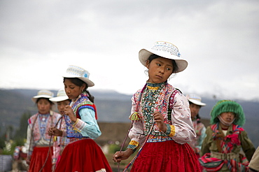 Peru. Children in traditional costume dancing at yanque, colca canyon