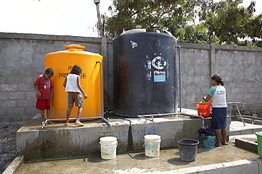 East timor. Camp for internally displaced people (idps) at the don bosco center in dili. Water tanks