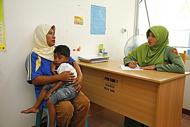 Indonesia government health clinic (pos kesmas) at cot seumereng, desa pucoh leung. mother with sick child come for consultation. meulaboh, aceh