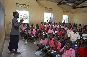 South sudan lutaya primary school, constructed and financed by jesuit refugee services since 2005, yei. lesson taking place in one of the classrooms. some classes have over 100 children. most classes do not have desks or seats. children often bring their own stools to sit on