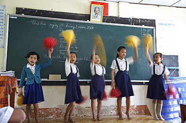 Vietnam hoa binh primary school in vinh long province. children in school practice cheerleading