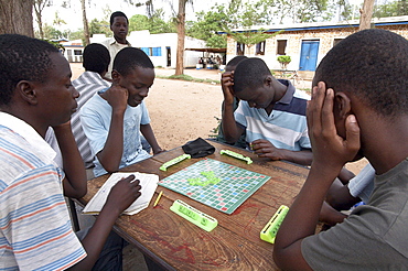 Tanzania boys playing scrabble, recreation center, musoma