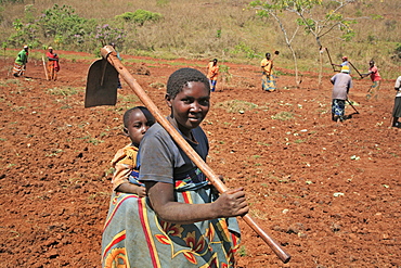 Burundi woman carrying a hoe, gitera.