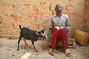 Burundi boy with goat, gitera.