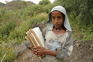 Child, ethiopia. Tullo gudo island and its monastery of debre zion, lake ziway. Girl walking to school carrying her books