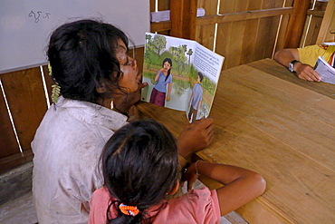 CAMBODIA Katot village, inhabited by the Prov tribal group, Stung Treng district. Library and literacy building provided by DPA and SCIAF. Children reading books