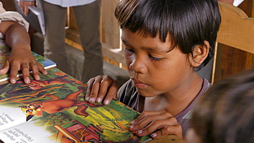 CAMBODIA Katot village, inhabited by the Prov tribal group, Stung Treng district. Library and literacy building provided by DPA and SCIAF. Children reading books