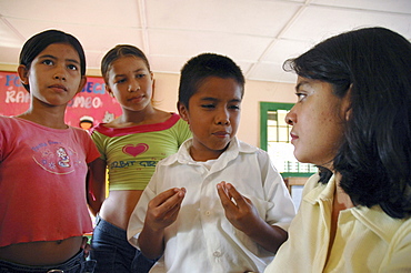 Colombia extra-curricular seminar in a middle school at la paz, barrancabermeja, in which children discuss violence in their community, and their personal experiences. Many had witnessed killings and dead bodies at close range. The seminars are organised by dni, international defense of children. Their town is one of the most violent in colombia. Ana victoria huertas of dni is leading the group at this session