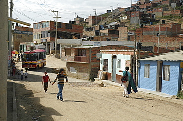 Colombia children running through the sprawling slum of altos de cazuca, bogota