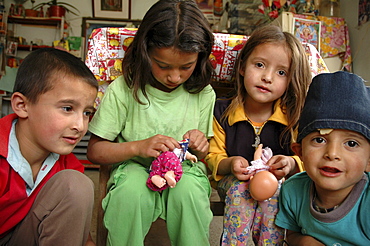 Colombia sisters playing with their dolls, the slum of altos de cazuca, bogota,