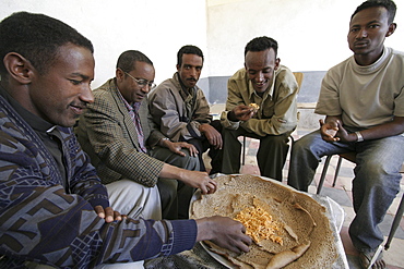 Ethiopia men eating a meal at wutafa, tigray