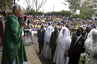 Kenya at a wedding mass, kibera slum, nairobi. Three couples were married at the same time, by american maryknoll priest, father bob jalbert