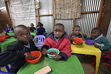 Kenya day care center in kibera slum, nairobi. Meal time at the center