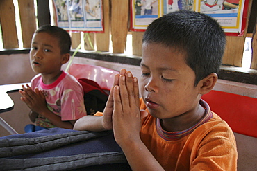 Thailand buddhist children praying at damanaruk childrens village