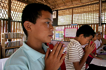 Thailand buddhist children praying at damanaruk childrens village