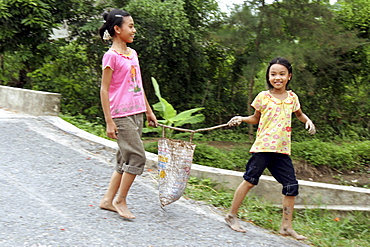 Vietnam girls carrying bag together, nam dinh