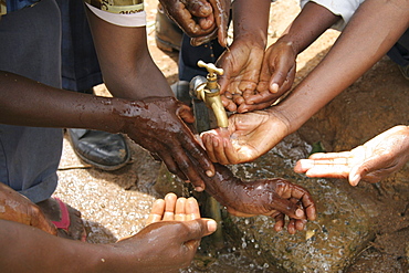 Tanzanian villagers washing their hands after installing water system for their village. This is a project of caritas tanzania financed by caritas australia, and will bring safe drinking water to the region for the first time. Previously people would have to collect, often unsafe, drinking water from distant streams and carry it in buckets on their heads. Kighare, same, in the north-east near kilimanjaro