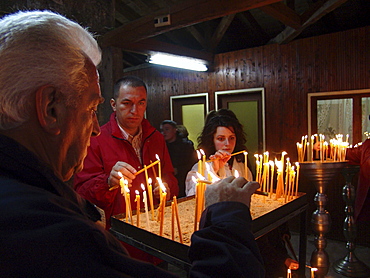 Macedonia (the former yugoslav republic of macedonia, fyrm) worshippers with candles at saint clement orthodox church, ohrid, on easter saturday night