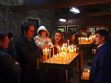 Macedonia (the former yugoslav republic of macedonia, fyrm) worshippers with candles at saint clement orthodox church, ohrid, on easter saturday night