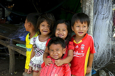 CAMBODIA Group of children. Don Tok village, Kampot, lies beside a river estuary and is often flooded by sea water, a consequence of climate change during the last few years. CRS is studying the problem through its partner agency, SCW (Save Cambodian Wildlife). Local children and families who are being affected by local flooding. photo by Sean Sprague