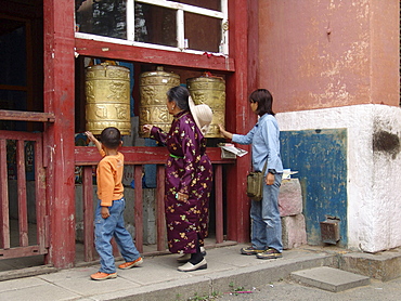 Mongolia pilgrims spinning prayer wheels gandan monastery, ulaan baatur