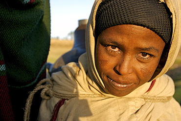 Women fetching water early in the morning. The wells in this area are empty during the dry season,forcing women to walk very long distance to fetch water in the nearest river bed. Ethiopia