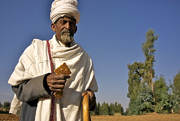 Old man, priest, in walking in the different villages of the hanamerant area,meket,ethiopia. He is people on his way . Ehtiopians are mainly christians with strong believe in angels. Ethiopia