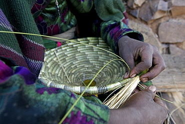 Women working at traditional basket. Most of the furniture in the houses are made out of natural element like sisal,wood or mud. Ethiopia